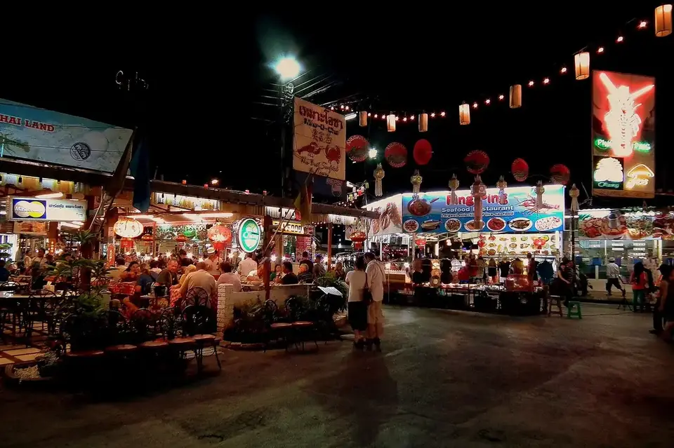 Chiang Mai Night Bazaar at night, with lanterns strung over the market and food stalls
