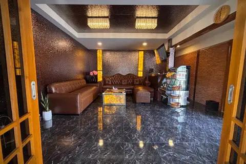 House of Nox: lounge with leather sofa and marble floor