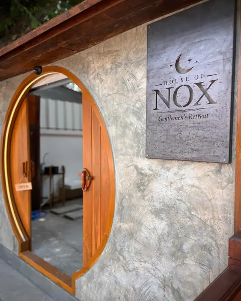 House of Nox: round wooden door with House of Nox sign