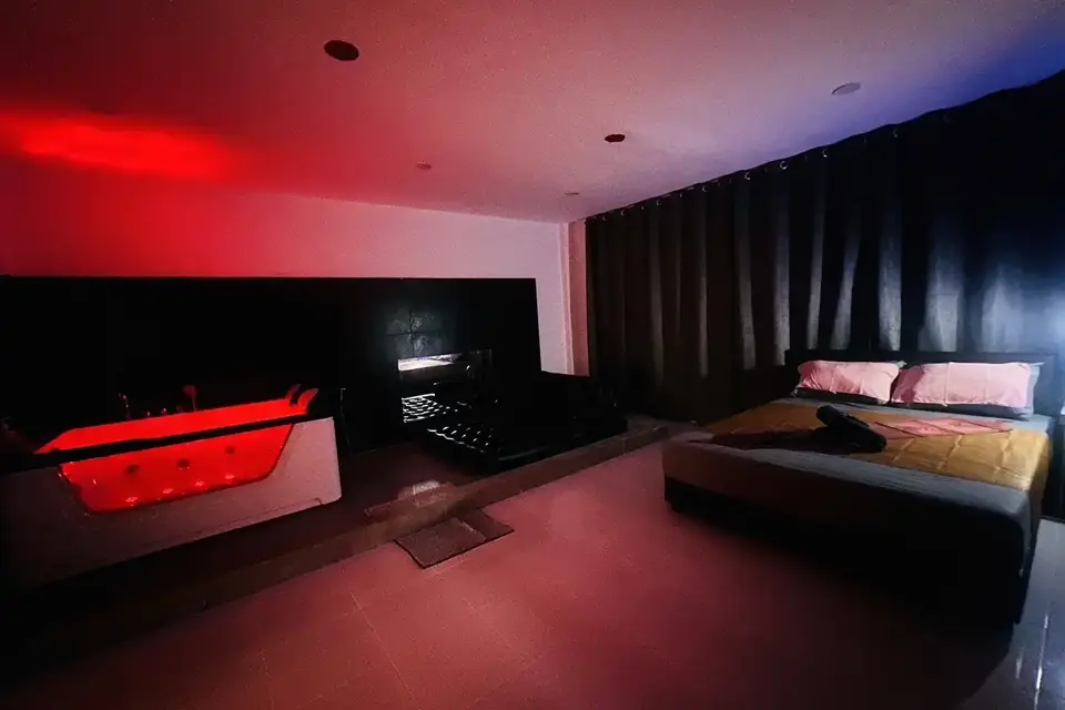 Nuru Spa: red-lit room with a glowing jacuzzi and bed