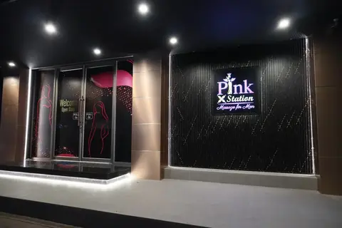 Pink X Station entrance with dark glass facade